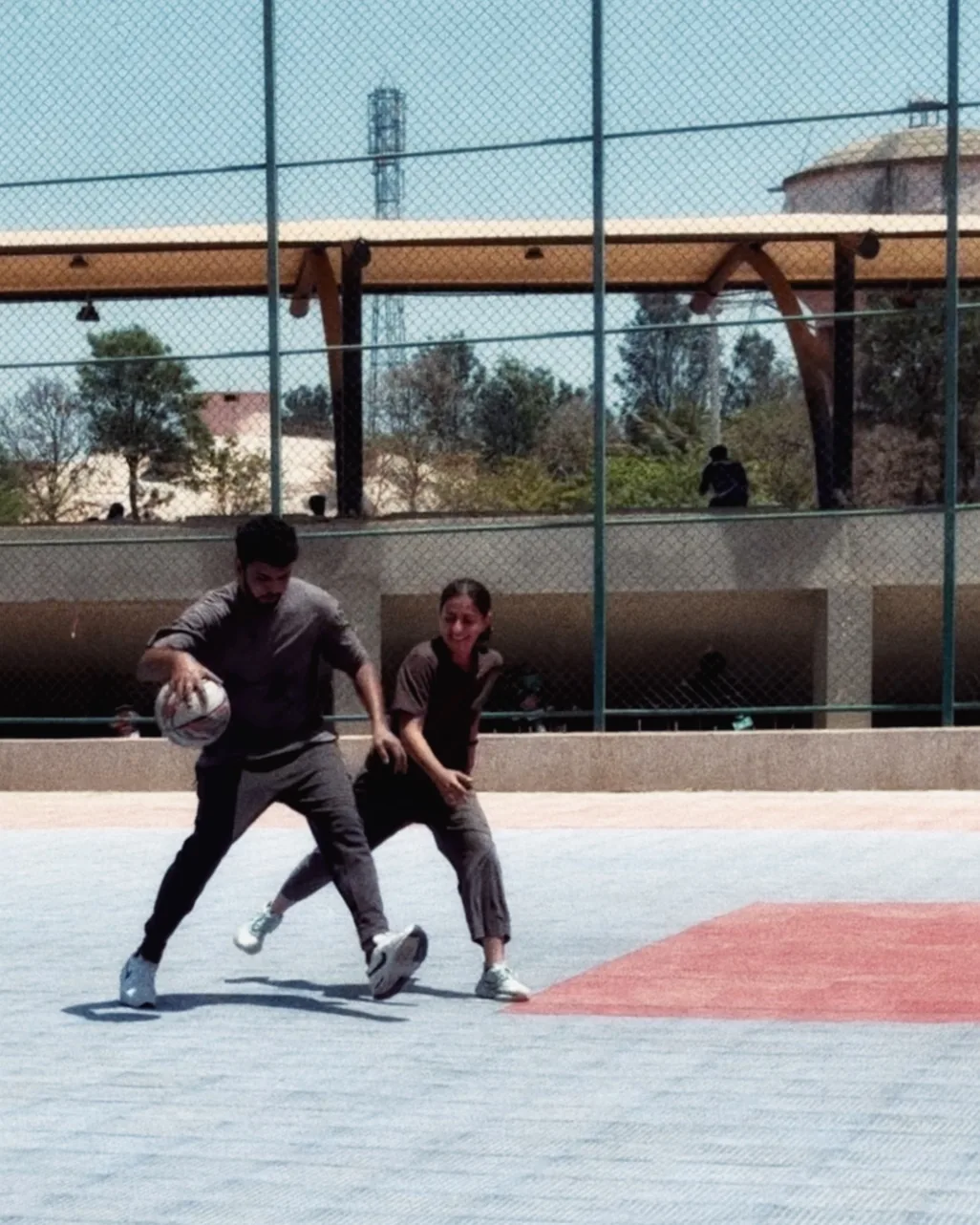 Alvin dribbling a basketball on an outdoor court